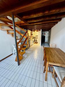 a room with a wooden table and a staircase at Apartments San Biagio in Vicenza
