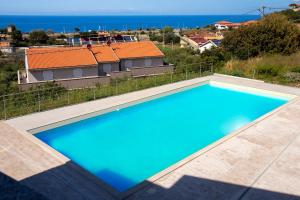 a large swimming pool on the roof of a house at Ad occhi aperti - Castelsardo in Castelsardo