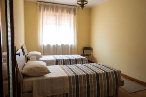 a bedroom with two beds and a window at Casa vacanza Semia in Vinadio