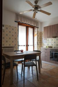 a dining room table with chairs and a ceiling fan at Casa vacanza Semia in Vinadio