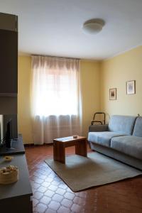 a living room with a blue couch and a coffee table at Casa vacanza Semia in Vinadio +4 photos