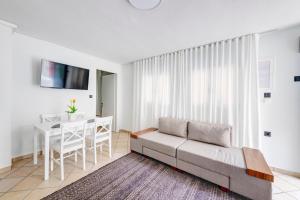 a living room with a couch and a table at VICE by Apiro Syros in Ermoupoli