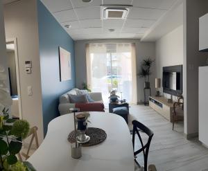 a living room with a table and a couch at Appartement Calina in Freyming