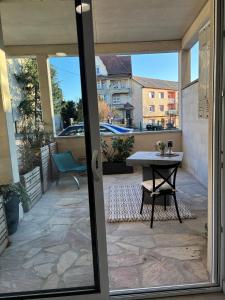 a sliding glass door with a table on a patio at Appartement Calina in Freyming