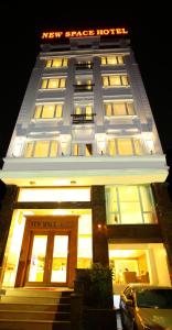 a new stress hotel with a car parked in front of it at New Space Hotel Airport in Ho Chi Minh City