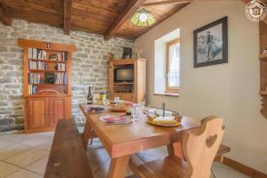a dining room with a wooden table and chairs at Chalet Blanchon in Montricher-Albanne