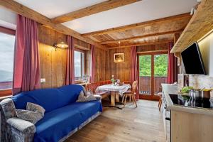 a living room with a blue couch and a table at Galtinerhof in Rodengo
