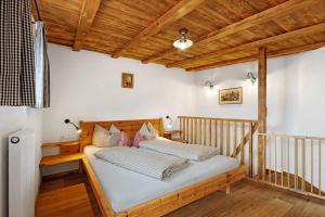 a bedroom with a bed in a room with wooden ceilings at Galtinerhof in Rodengo