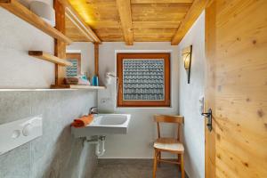 a bathroom with a sink and a wooden ceiling at Galtinerhof in Rodengo +116 photos