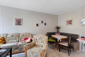 a living room with a couch and a table and chairs at Wohnung Im Hinterhof in Querfurt