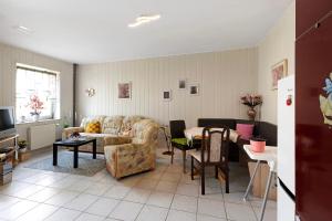 a living room with a couch and a table at Wohnung Im Hinterhof in Querfurt