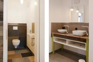 a bathroom with two sinks and a toilet at Ferienwohnungen beim Weilerbauer in Gerstetten +20 photos