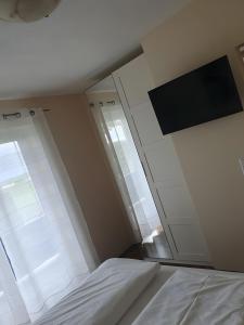 a bedroom with a bed and a large window at Hotel Sonnenhof in Illertissen
