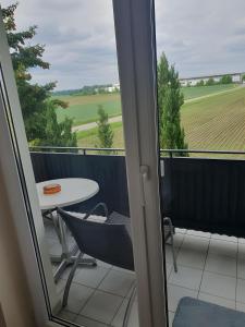 a balcony with a table and a view of a field at Hotel Sonnenhof in Illertissen