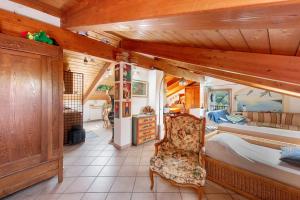 a bedroom with a bed and a chair in a room at La Liguria tra gli Ulivi 2 in Varazze