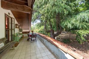a porch of a house with a table and chairs at La Liguria tra gli Ulivi 2 in Varazze +21 photos