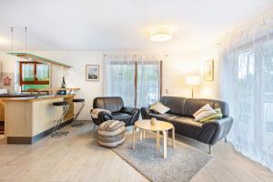 a living room with a couch and a table at Ferienwohnung Sonnenberg in Degerfelden