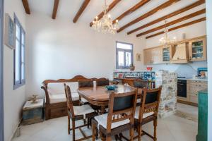 a kitchen and dining room with a wooden table and chairs at Orkos View House in Naxos Chora +20 photos