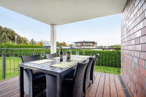 a dining table on a deck with a view at Kleine Auszeit - Hohe Lith in Cuxhaven