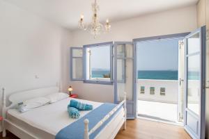 a bedroom with a bed with a view of the ocean at Orkos View House in Naxos Chora
