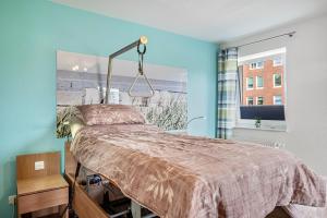 a bedroom with a bed and a picture of a beach at Kleine Auszeit - Hohe Lith in Cuxhaven