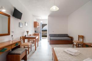 a living room with a couch and a table at Galanos Studios Naxos in Naxos Chora