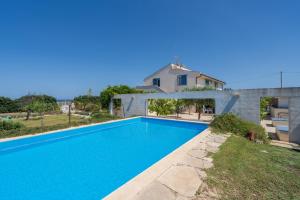 a large swimming pool in front of a house at Melus Maris in Syracuse