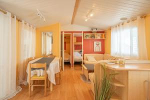 a living room with a table and a couch at Mh 61 La Tremblade in La Tremblade