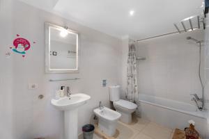 a white bathroom with a sink and a toilet at Villa en Taro in Güimar +28 photos