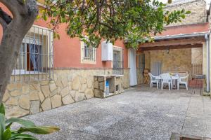 a patio with a table and chairs in front of a building at Como En Casa Jerez in Jerez de la Frontera