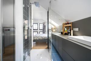 a bathroom with a glass shower and a sink at Seezauber in Malchow