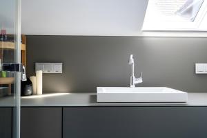 a bathroom counter with a white sink in it at Seezauber in Malchow +4 photos