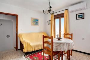 a small dining room with a table and a window at Casa Ángela in Conil de la Frontera