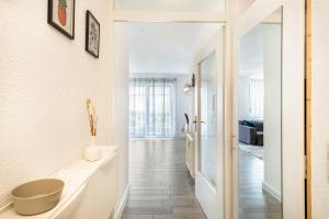 a bathroom with a sink and a mirror at Tulips Apartment in Meckenbeuren +16 photos