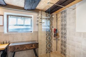 a shower with a glass door in a bathroom at Schwarzwald Ruhe in Altensteig +21 photos