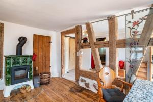 a living room with a fireplace and a stove at Schwarzwald Ruhe in Altensteig