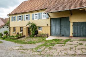 a yellow house with a brown roof at Schwarzwald Ruhe in Altensteig