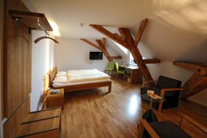 a room with a bed and a table with chairs at ODELYA - Stadthotel im Park in Basel