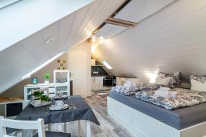 a bedroom with a bed and a dining room at Opitz in Allensbach +7 photos