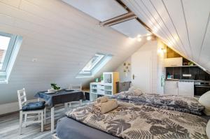 a bedroom with a bed and a table in a room at Opitz in Allensbach