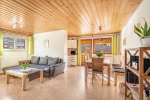 a living room with a couch and a table at Haus Schöneck in Todtnauberg