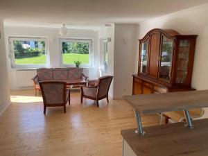 a living room with a dining room table and chairs at Hofberg Villa in Landshut
