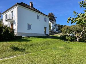 a large white house with a grassy yard at Hofberg Villa in Landshut