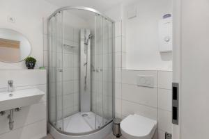 a bathroom with a shower and a toilet and a sink at Fewo Mca in Rielasingen-Worblingen +13 photos