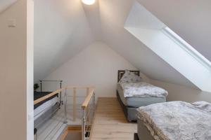a attic room with two beds and a staircase at Fewo Mca in Rielasingen-Worblingen