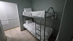two bunk beds in a room next to a wall at Pendleberry Unit 85 in Warmbaths +12 photos