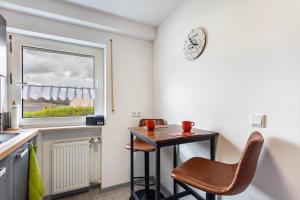 a small table and chair in a kitchen with a window at Ferienwohnung Wilde Schanze in Hoppecke