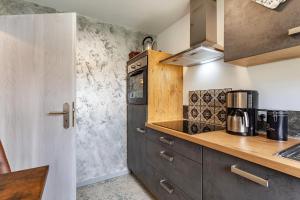 a kitchen with a stove and a counter top at Ferienwohnung Wilde Schanze in Hoppecke