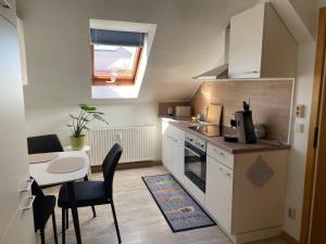 a small kitchen with a table and a dining room at Mein kleines Reich in Zwickau