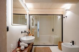 a bathroom with a white sink and a shower at Archè Luxury private Spa in Polignano a Mare +20 photos
